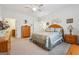 Spacious main bedroom features neutral tones, ceiling fan, and carpeted floors at 119 Holiday Road, Unit 301 Rd # 301, Buford, GA 30518