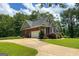 Charming home featuring a brick exterior, attached garage, and manicured lawn at 172 Sam Solomon Rd, Locust Grove, GA 30248