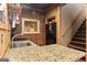 Kitchenette features granite counters, wood accents, brick back splash, and a black refrigerator at 172 Sam Solomon Rd, Locust Grove, GA 30248