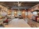 Open living area with wood paneling, comfortable seating, and natural light from the windows at 172 Sam Solomon Rd, Locust Grove, GA 30248
