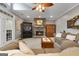 Living room boasts a stone fireplace, ceiling fan, plush seating and lots of natural light at 172 Sam Solomon Rd, Locust Grove, GA 30248