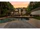 Backyard featuring pool, patio, and lush landscaping creates a serene outdoor retreat at 307 Bellingrath Ct, Peachtree City, GA 30269