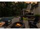 Backyard with a stone firepit with pool and mature trees, perfect for relaxation and entertaining at 307 Bellingrath Ct, Peachtree City, GA 30269