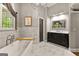 Stylish bathroom features a soaking tub, a glass shower, and a dark wood vanity at 307 Bellingrath Ct, Peachtree City, GA 30269