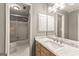 Bathroom featuring a marble vanity, cabinets, and shower-tub combination with sliding glass door at 307 Bellingrath Ct, Peachtree City, GA 30269