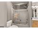 Bathroom featuring a toilet, shower-tub combination with sliding glass door, and grey walls at 307 Bellingrath Ct, Peachtree City, GA 30269