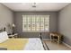 Bedroom with a ceiling fan, carpet floors, and large window providing natural light at 307 Bellingrath Ct, Peachtree City, GA 30269