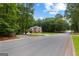 Beautiful home on a corner lot has a manicured lawn and lush trees at 307 Bellingrath Ct, Peachtree City, GA 30269