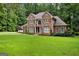 Charming two-story brick home has a well-manicured lawn and updated shutters at 307 Bellingrath Ct, Peachtree City, GA 30269