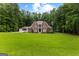 Stately brick two-story home boasts mature trees, a manicured lawn, and a three-car garage at 307 Bellingrath Ct, Peachtree City, GA 30269