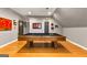 Well-lit bonus room includes pool table, recessed lights, hardwood floors, and TV at 307 Bellingrath Ct, Peachtree City, GA 30269