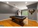 Upstairs bonus room features a pool table, hardwood floors, and unique wood art at 307 Bellingrath Ct, Peachtree City, GA 30269