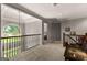 Upstairs hallway features a window and decorative woodwork, adding architectural interest and warmth at 307 Bellingrath Ct, Peachtree City, GA 30269