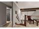Upstairs hallway with carpet, wood beams, a sitting chair, and an open door to a bedroom at 307 Bellingrath Ct, Peachtree City, GA 30269