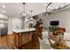 Well-lit kitchen with hardwood floors, modern island, stainless steel appliances, and a view of the dining area at 307 Bellingrath Ct, Peachtree City, GA 30269