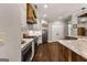 Modern kitchen features a large island, stainless steel appliances, and sleek white cabinetry at 307 Bellingrath Ct, Peachtree City, GA 30269