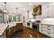 Charming kitchen boasts an island with farmhouse sink, stainless appliances, and a custom range hood at 307 Bellingrath Ct, Peachtree City, GA 30269