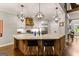 Stylish kitchen features a large island with seating, modern appliances, and custom cabinetry at 307 Bellingrath Ct, Peachtree City, GA 30269