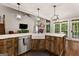 Bright kitchen boasts granite countertops, a farmhouse sink, and a view to the great room at 307 Bellingrath Ct, Peachtree City, GA 30269