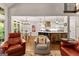 Inviting living room with hardwood floors, comfortable seating, and view to a well-equipped kitchen at 307 Bellingrath Ct, Peachtree City, GA 30269