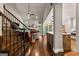 Open living room and kitchen area showcasing a staircase, fireplace, and wood flooring at 307 Bellingrath Ct, Peachtree City, GA 30269