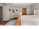 Spacious main bedroom featuring hardwood floors, a tray ceiling and a sliding barn door at 307 Bellingrath Ct, Peachtree City, GA 30269
