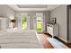 Bright main bedroom boasts natural light with a dresser, shutters, and area rug at 307 Bellingrath Ct, Peachtree City, GA 30269
