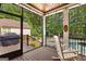 Screened porch with a rocking chair, wood floors and outdoor living space with a pool at 307 Bellingrath Ct, Peachtree City, GA 30269