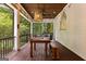 Comfortable screened-in porch with wood beam ceiling, dining table, and outdoor views at 307 Bellingrath Ct, Peachtree City, GA 30269