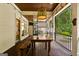 Outdoor dining on a screened porch with ceiling fan and outdoor views at 307 Bellingrath Ct, Peachtree City, GA 30269