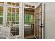 Open view from interior doorway of a screened in porch with exterior greenery at 307 Bellingrath Ct, Peachtree City, GA 30269