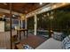 Charming screened porch with inviting string lights, comfortable seating, and views of the pool area at 307 Bellingrath Ct, Peachtree City, GA 30269