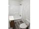 Functional bathroom featuring a tub, toilet, shower, and a sink on new grey vinyl flooring at 602 Mccurdy Rd, Villa Rica, GA 30180