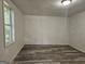 View of an empty room featuring new wood flooring, clean windows, and freshly painted walls at 602 Mccurdy Rd, Villa Rica, GA 30180