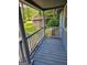 Inviting porch view featuring wood flooring, grey railings, and exterior views of greenery and a shed at 602 Mccurdy Rd, Villa Rica, GA 30180