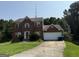 Charming two-story brick home with attached garage and a well-maintained front yard, perfect for Gathering living at 2355 Burdett Ridge Dr, South Fulton, GA 30349