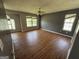 Bright living room featuring wood floors and multiple windows, creating a warm and inviting space for relaxation at 2355 Burdett Ridge Dr, South Fulton, GA 30349