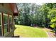 Expansive backyard featuring well-maintained lawn and a playset at 1310 Larkview Sw Dr, Lilburn, GA 30047