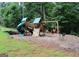 Backyard including a wooden playset and a natural wooded perimeter at 1310 Larkview Sw Dr, Lilburn, GA 30047