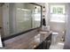 Bathroom features a granite countertop, a shower, and a toilet with matching hardware at 1310 Larkview Sw Dr, Lilburn, GA 30047