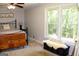 Bright bedroom with a large window, chest, and carpeted flooring at 1310 Larkview Sw Dr, Lilburn, GA 30047