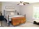 Cozy bedroom with a queen-sized bed, ceiling fan, and chest at 1310 Larkview Sw Dr, Lilburn, GA 30047