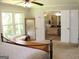 View from the bed into the ensuite bathroom with double doors and natural lighting at 1310 Larkview Sw Dr, Lilburn, GA 30047