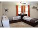 A shared ' bedroom featuring two twin beds, bright curtains, and a built-in nightstand at 1310 Larkview Sw Dr, Lilburn, GA 30047