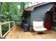 Wooden deck featuring chair seating, grill, and wooded views at 1310 Larkview Sw Dr, Lilburn, GA 30047