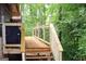 New wooden deck with wood and metal railing overlooking wooded backyard at 1310 Larkview Sw Dr, Lilburn, GA 30047