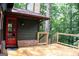 Open wooden deck with access to a backyard and colorful entry door at 1310 Larkview Sw Dr, Lilburn, GA 30047