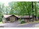 Charming brick home featuring a two-car garage and lush landscaping, creating an inviting curb appeal at 1310 Larkview Sw Dr, Lilburn, GA 30047
