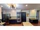 A kitchen featuring granite countertops, stainless steel appliances and navy and white cabinets at 1310 Larkview Sw Dr, Lilburn, GA 30047