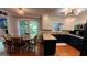 Modern kitchen featuring granite countertops, custom cabinetry, a wooden ceiling accent, and an adjacent dining area at 1310 Larkview Sw Dr, Lilburn, GA 30047